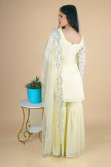 Light yellow sharara suit with embroidery work. It has a plain sharara and net dupatta. 