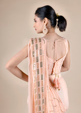 Peach dhoti saree in indowestern style. It has beautiful sequins embroidery work.