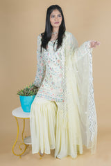 Light yellow sharara suit with embroidery work. It has a plain sharara and net dupatta. 