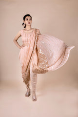 Peach dhoti saree in indowestern style. It has beautiful sequins embroidery work. 