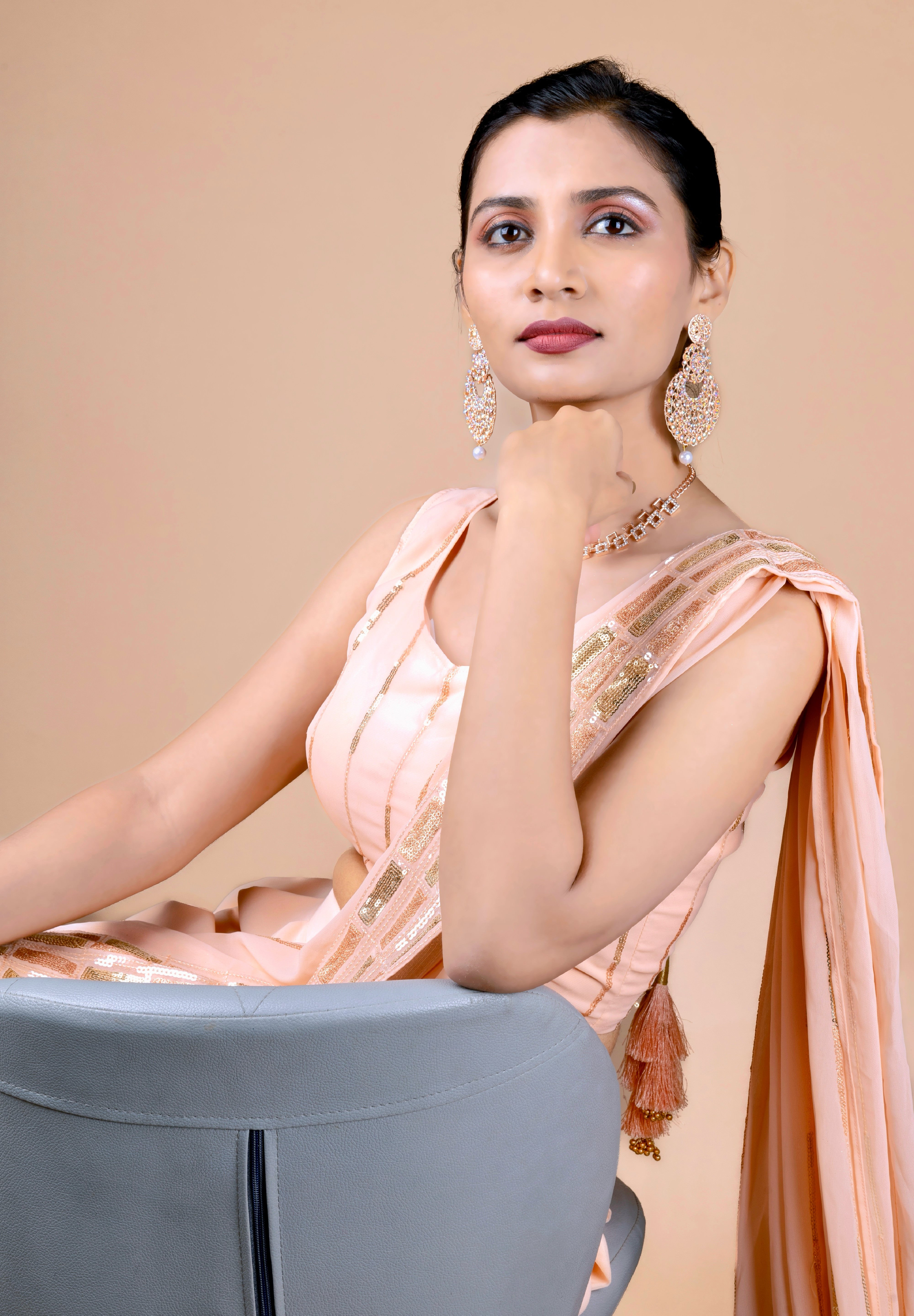 Peach dhoti saree in indowestern style. It has beautiful sequins embroidery work.