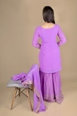 Purple sharara suit with full sleeves and zari embroidery work. The sharara has full flare. The dupatta is long and has the same work as the suit. 